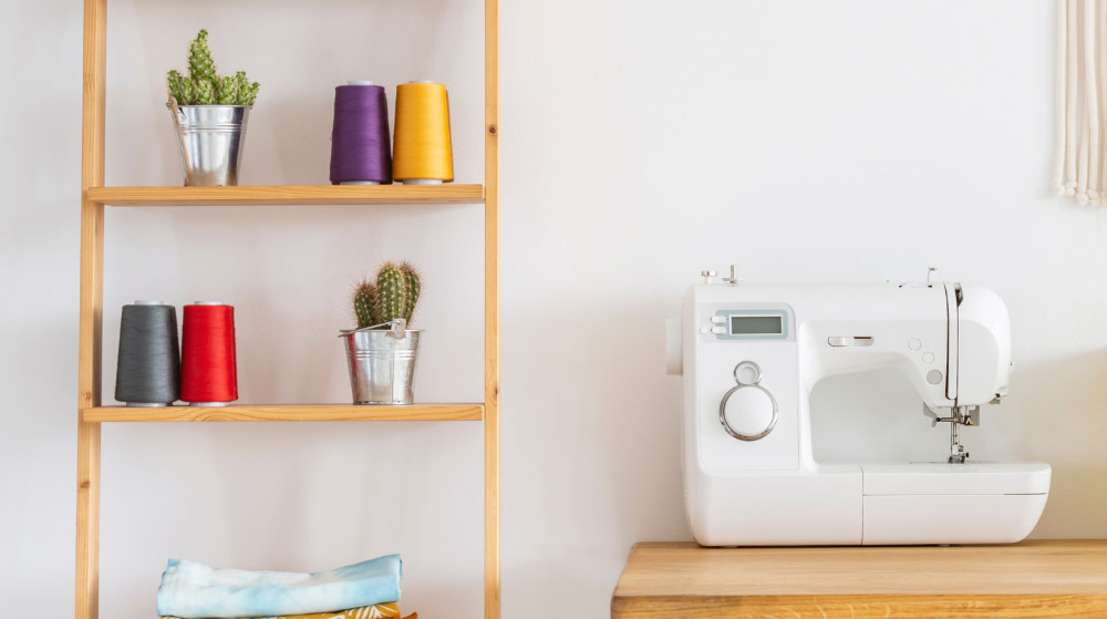 real photo sewing machine on desk | The Ultimate Sewing Cabinet Guide | Featured